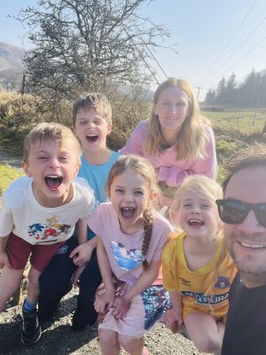 Laura with her family smiling outdoors after recovering from vestibular schwannoma surgery.