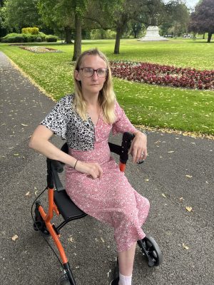 Laura using a mobility walker during recovery after acoustic neuroma brain surgery.
